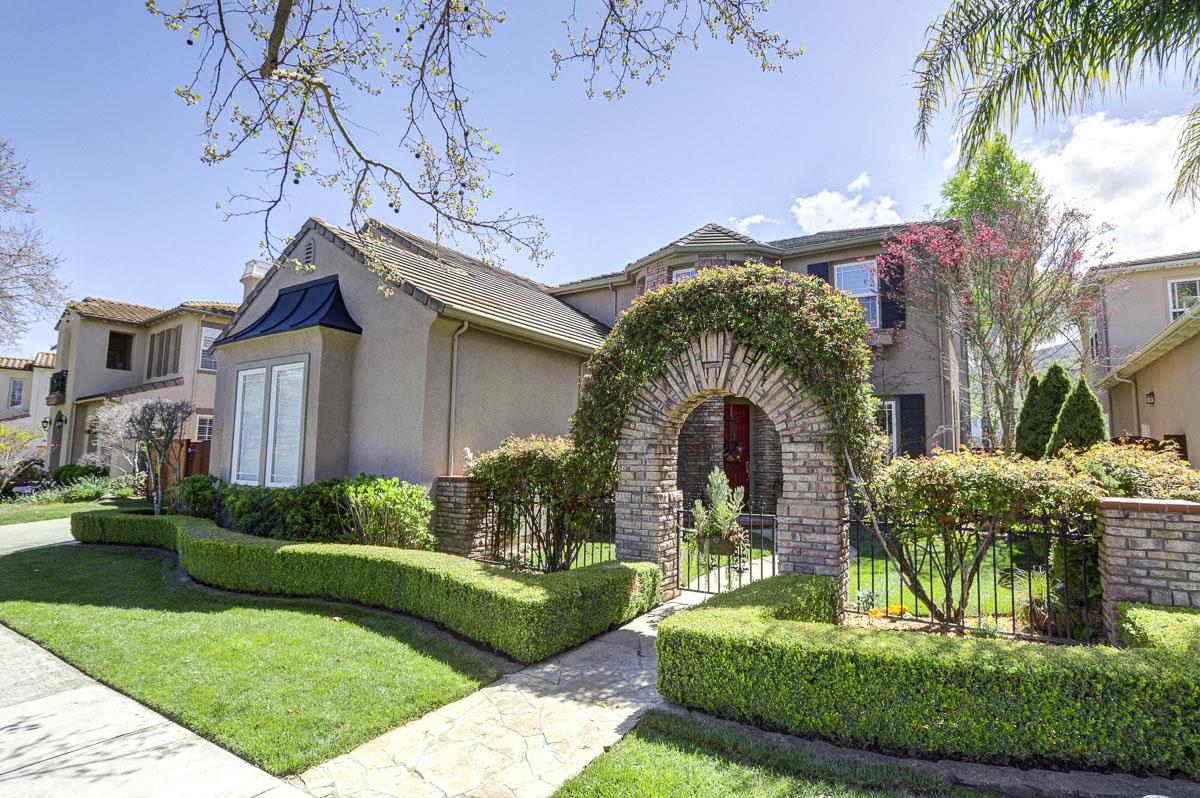 a front view of a house with a garden