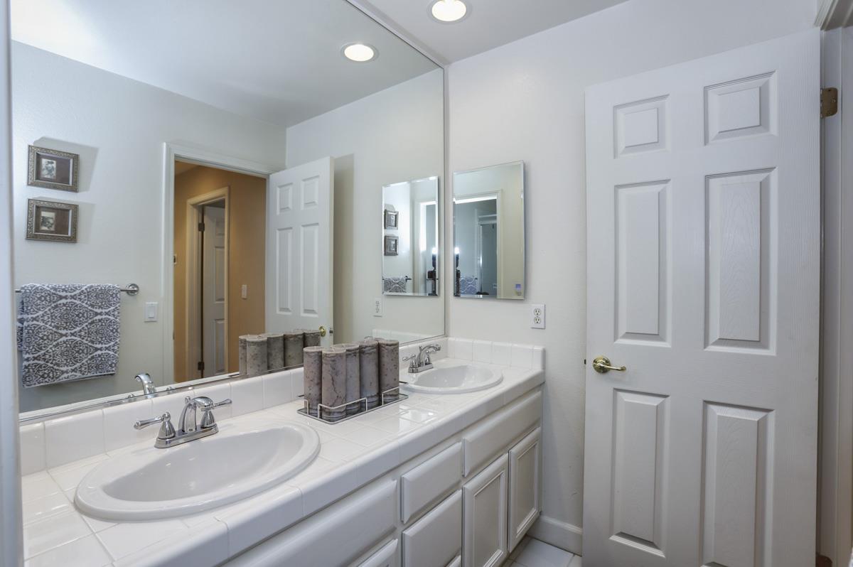 1949 St Andrews Circle, Unit CL Gilroy, CA 95020 - Photo 16 of 21 a bathroom with double vanity sinks and a mirror