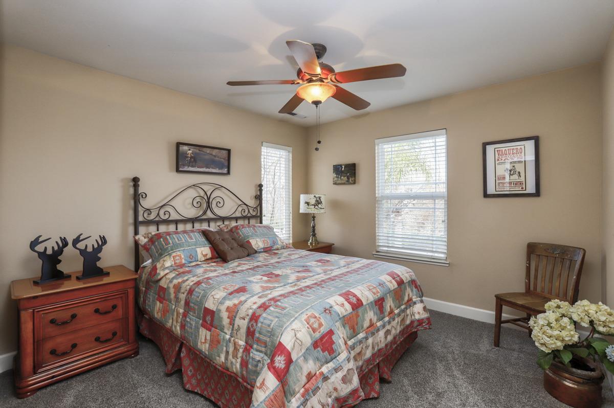 1949 St Andrews Circle, Unit CL Gilroy, CA 95020 - Photo 19 of 21 a bedroom with a bed and a chandelier
