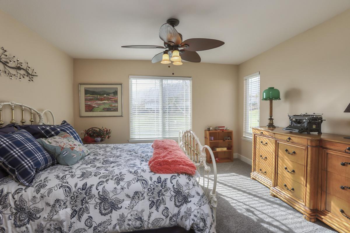 1949 St Andrews Circle, Unit CL Gilroy, CA 95020 - Photo 20 of 21 a bedroom with a large bed and a chandelier fan