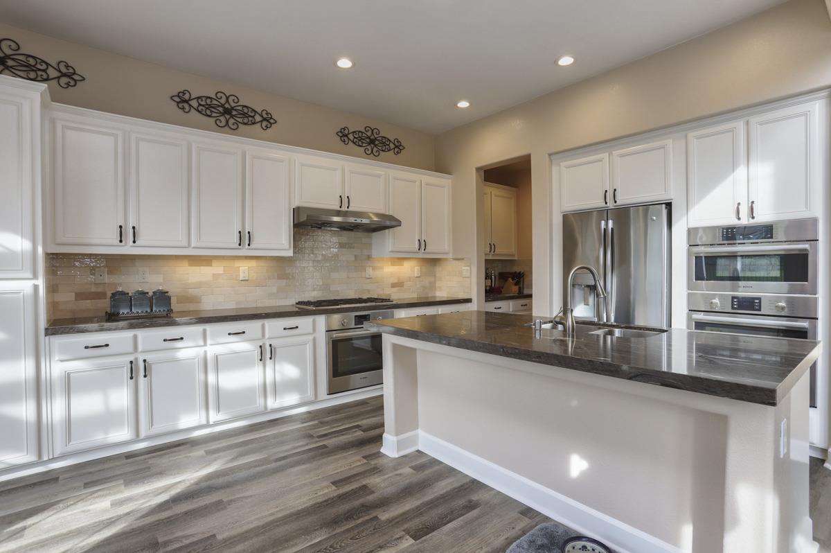 1949 St Andrews Circle, Unit CL Gilroy, CA 95020 - Photo 7 of 21 a kitchen with stainless steel appliances granite countertop a stove a sink and a refrigerator