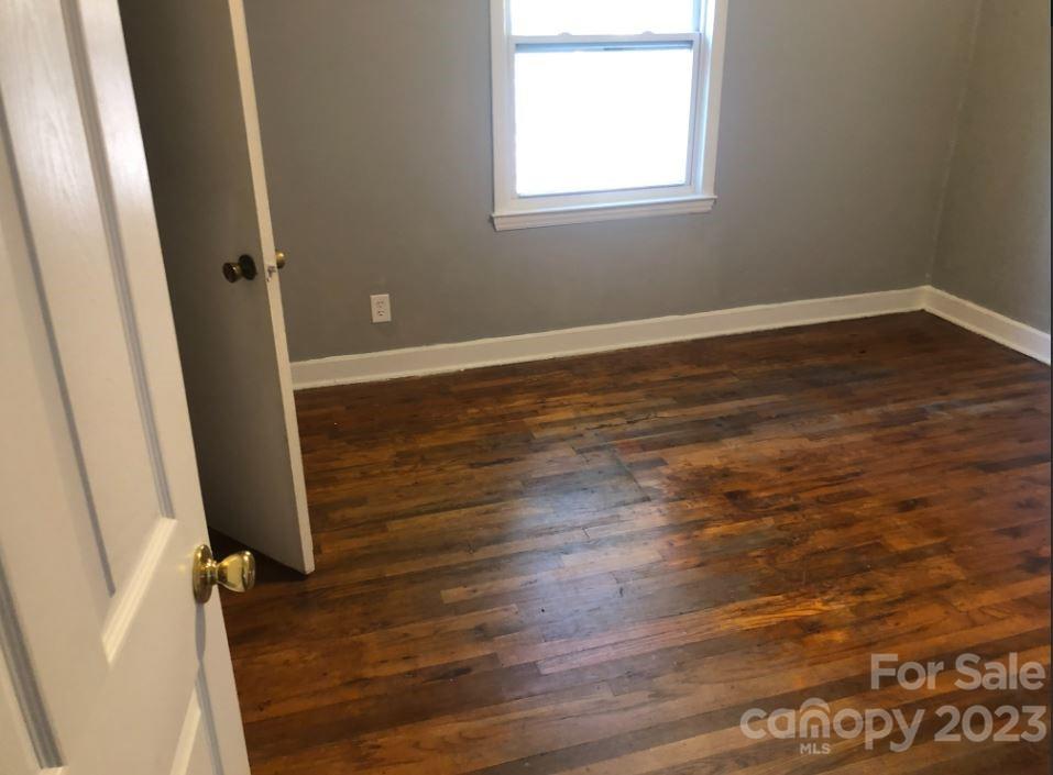 1702 Newland Road Charlotte, NC 28216 - Photo 16 of 34 an empty room with wooden floor and windows