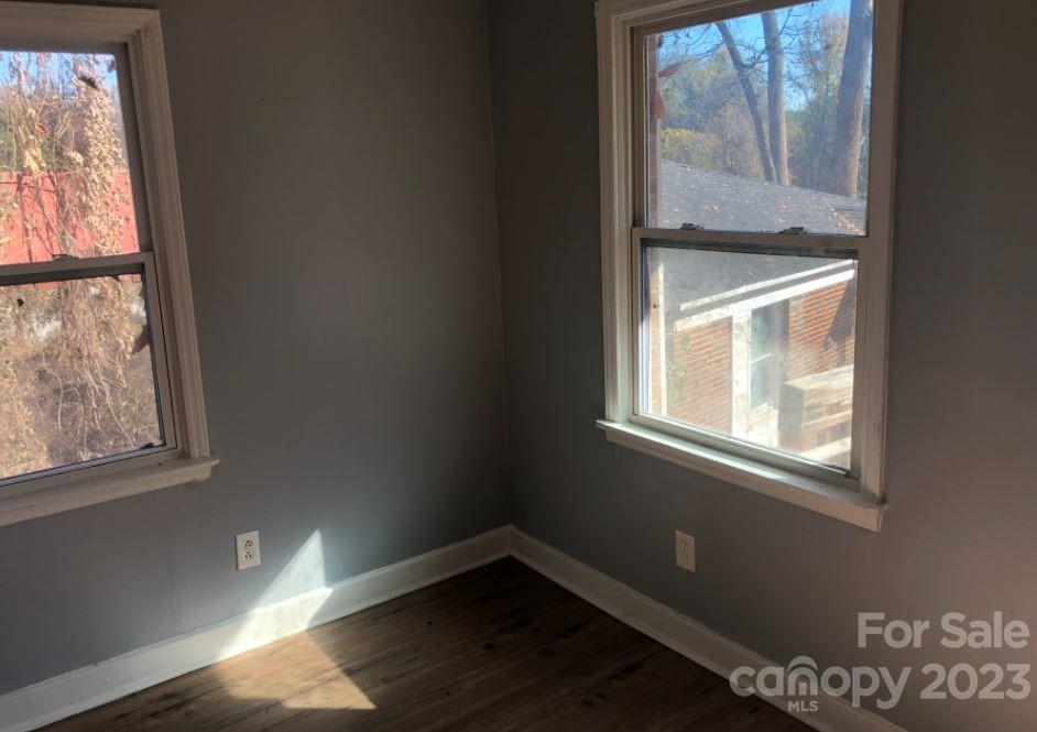 1702 Newland Road Charlotte, NC 28216 - Photo 23 of 34 a view of an empty room with wooden floor and a window