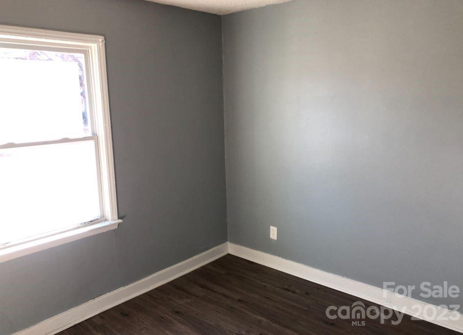 1702 Newland Road Charlotte, NC 28216 - Photo 31 of 34 a view of an empty room with wooden floor and a window