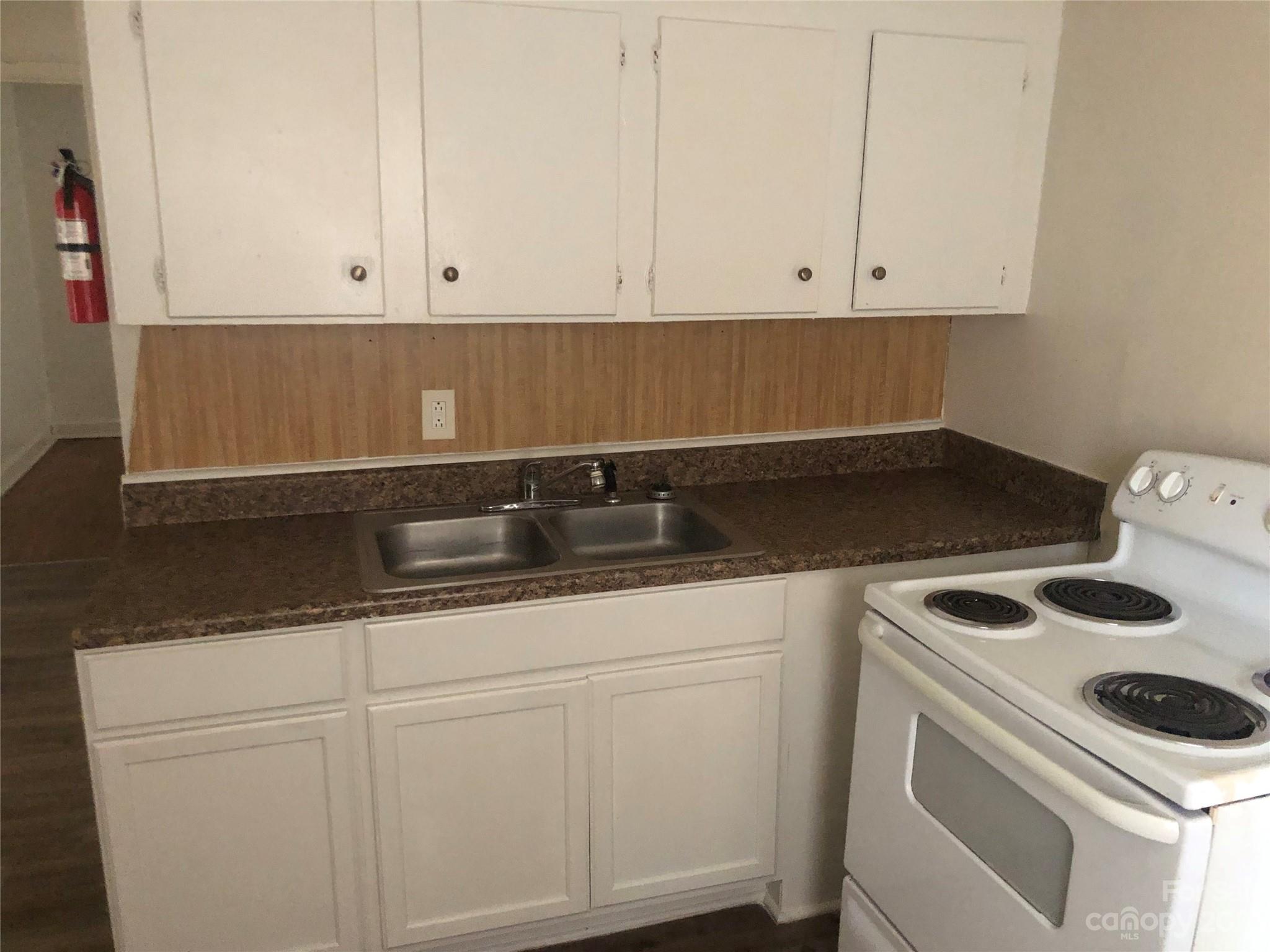 1702 Newland Road Charlotte, NC 28216 - Photo 33 of 34 a kitchen with white cabinets and white appliances