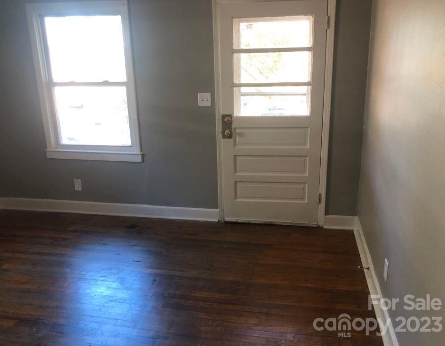 1702 Newland Road Charlotte, NC 28216 - Photo 7 of 34 an empty room with wooden floor and windows