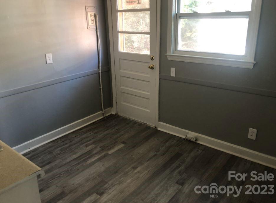1702 Newland Road Charlotte, NC 28216 - Photo 10 of 34 an empty room with wooden floor and windows