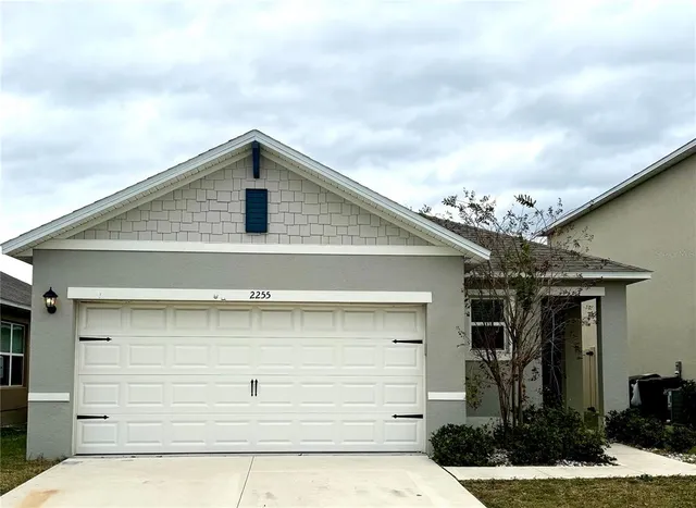 a front view of a house with garage
