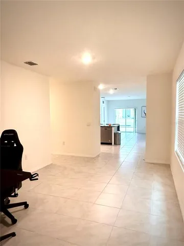 a view of empty room with wooden floor and cabinet