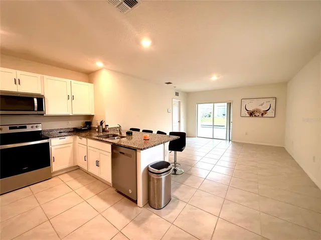 a kitchen with a sink a stove and a refrigerator