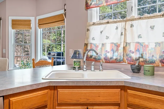 a kitchen with a sink and a large window