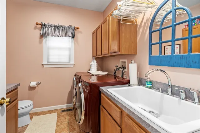 a bathroom with a granite countertop sink a toilet and a mirror
