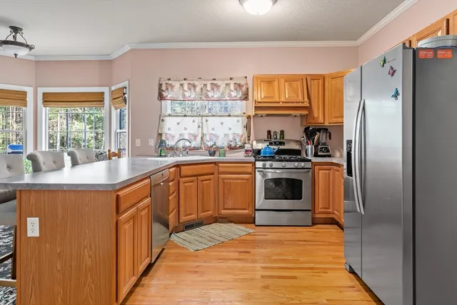 a kitchen with stainless steel appliances a stove sink and refrigerator