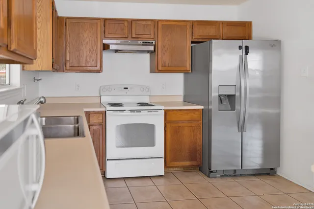 a kitchen with a stove top oven and cabinets