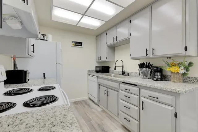 a kitchen with a sink stove and cabinets
