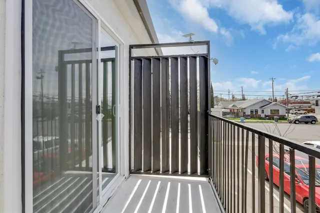 a view of a balcony with wooden floor