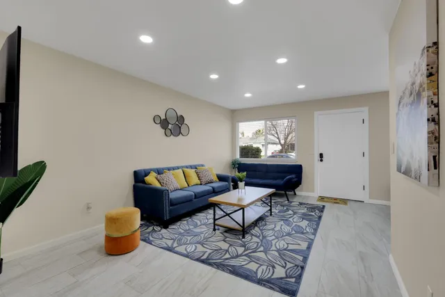 a living room with furniture and a rug