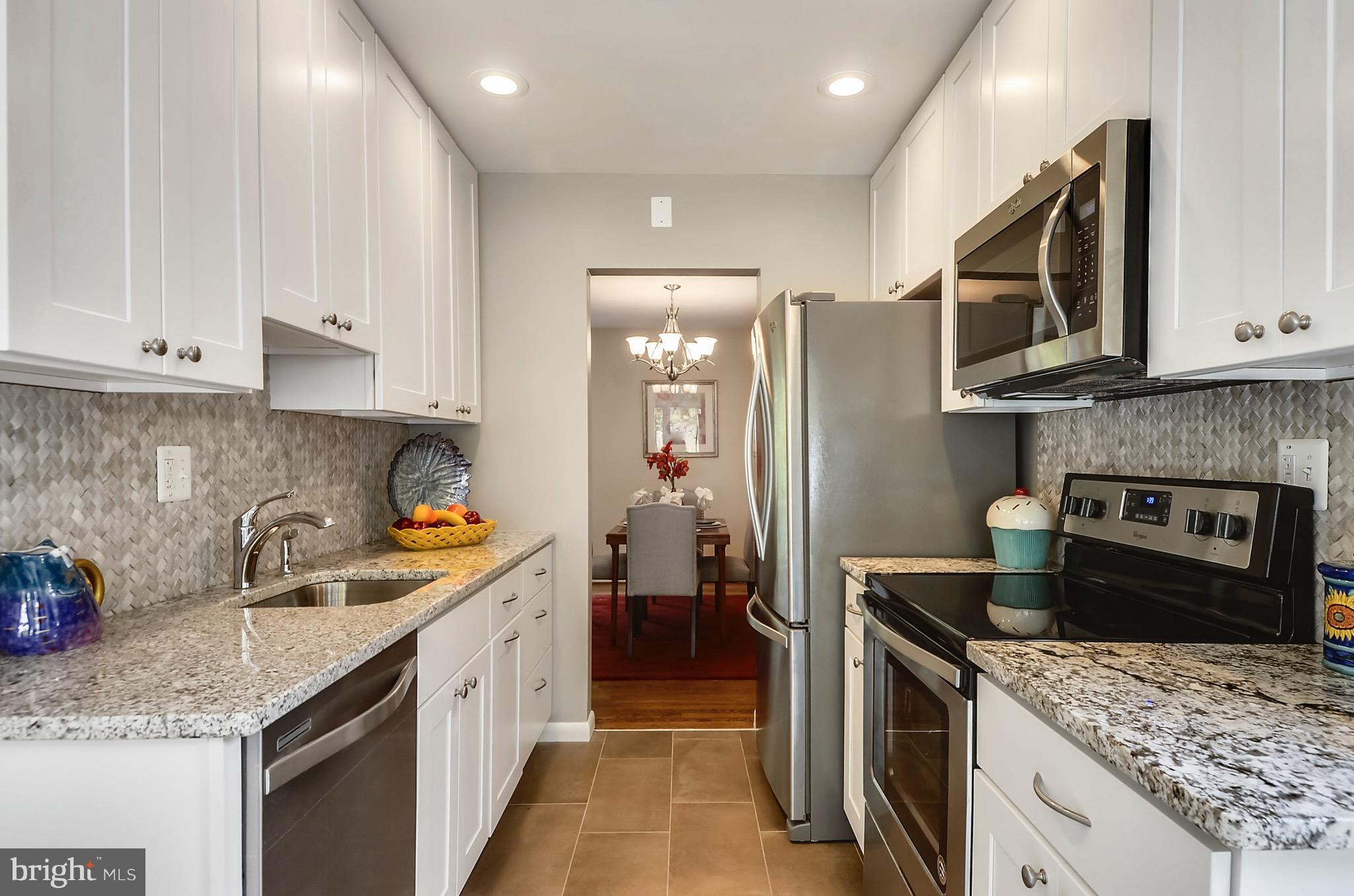 510 Waterford Road Silver Spring, MD 20901 - Photo 2 of 30 a kitchen with stainless steel appliances granite countertop a sink stove and refrigerator