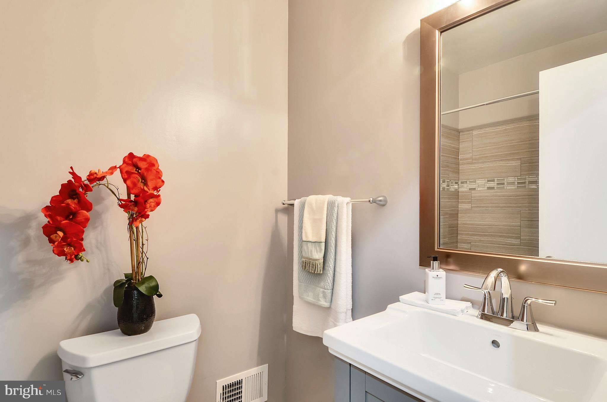 510 Waterford Road Silver Spring, MD 20901 - Photo 13 of 30 a bathroom with a sink vanity mirror and toilet