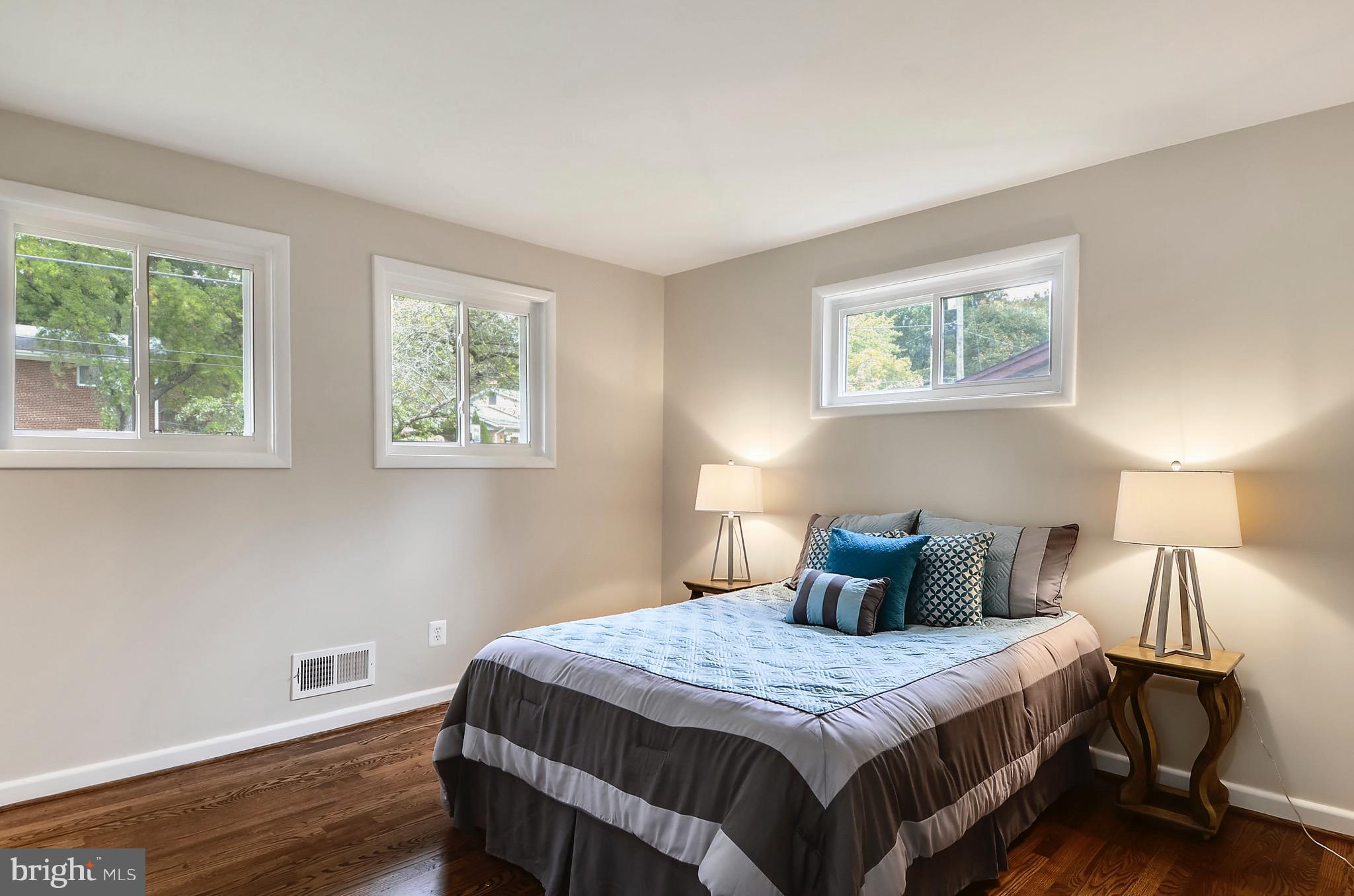 510 Waterford Road Silver Spring, MD 20901 - Photo 15 of 30 a bedroom with a bed and wooden floor