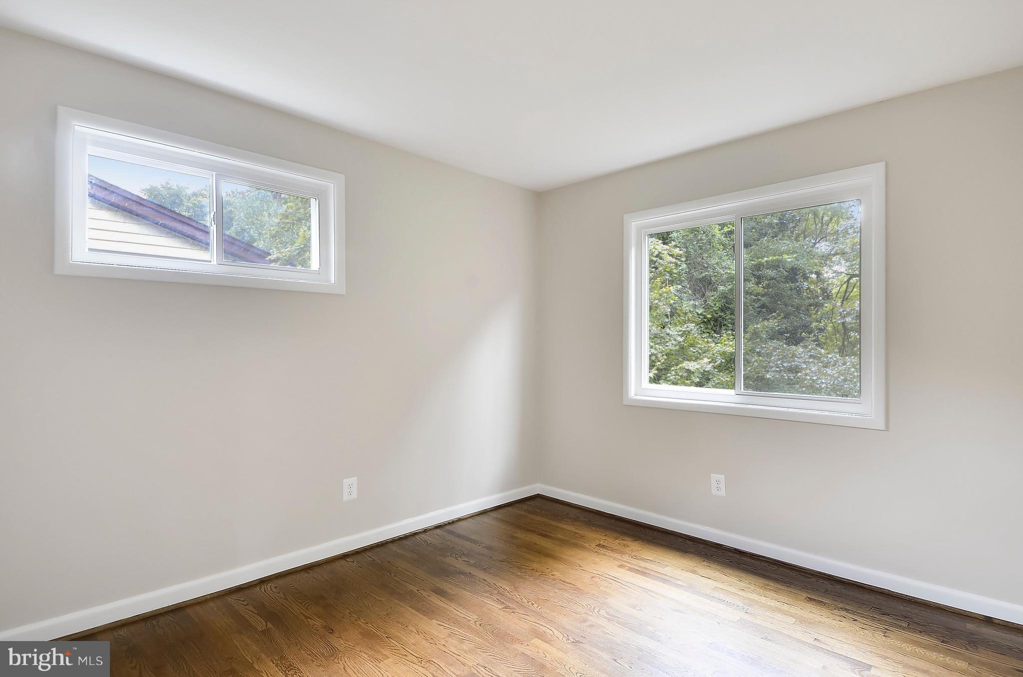 510 Waterford Road Silver Spring, MD 20901 - Photo 18 of 30 a view of an empty room with wooden floor and a window