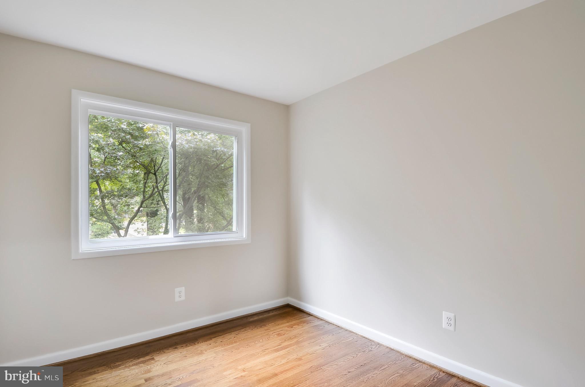 510 Waterford Road Silver Spring, MD 20901 - Photo 19 of 30 an empty room with wooden floor and windows