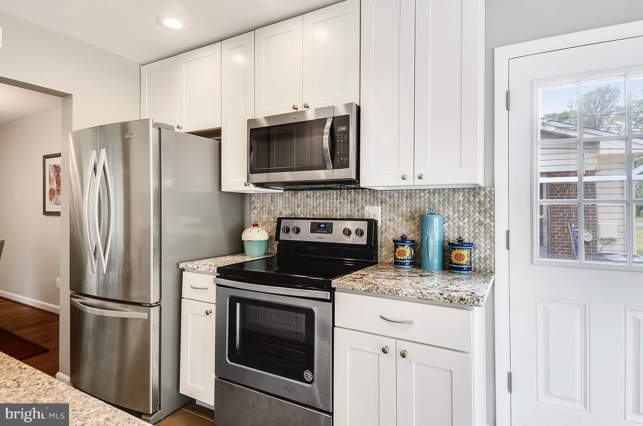 510 Waterford Road Silver Spring, MD 20901 - Photo 3 of 30 a kitchen with stainless steel appliances granite countertop a refrigerator stove and microwave