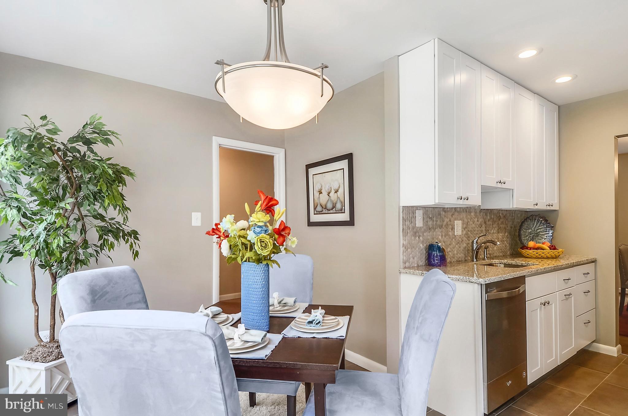 510 Waterford Road Silver Spring, MD 20901 - Photo 7 of 30 a view of a dining room with furniture and a potted plant
