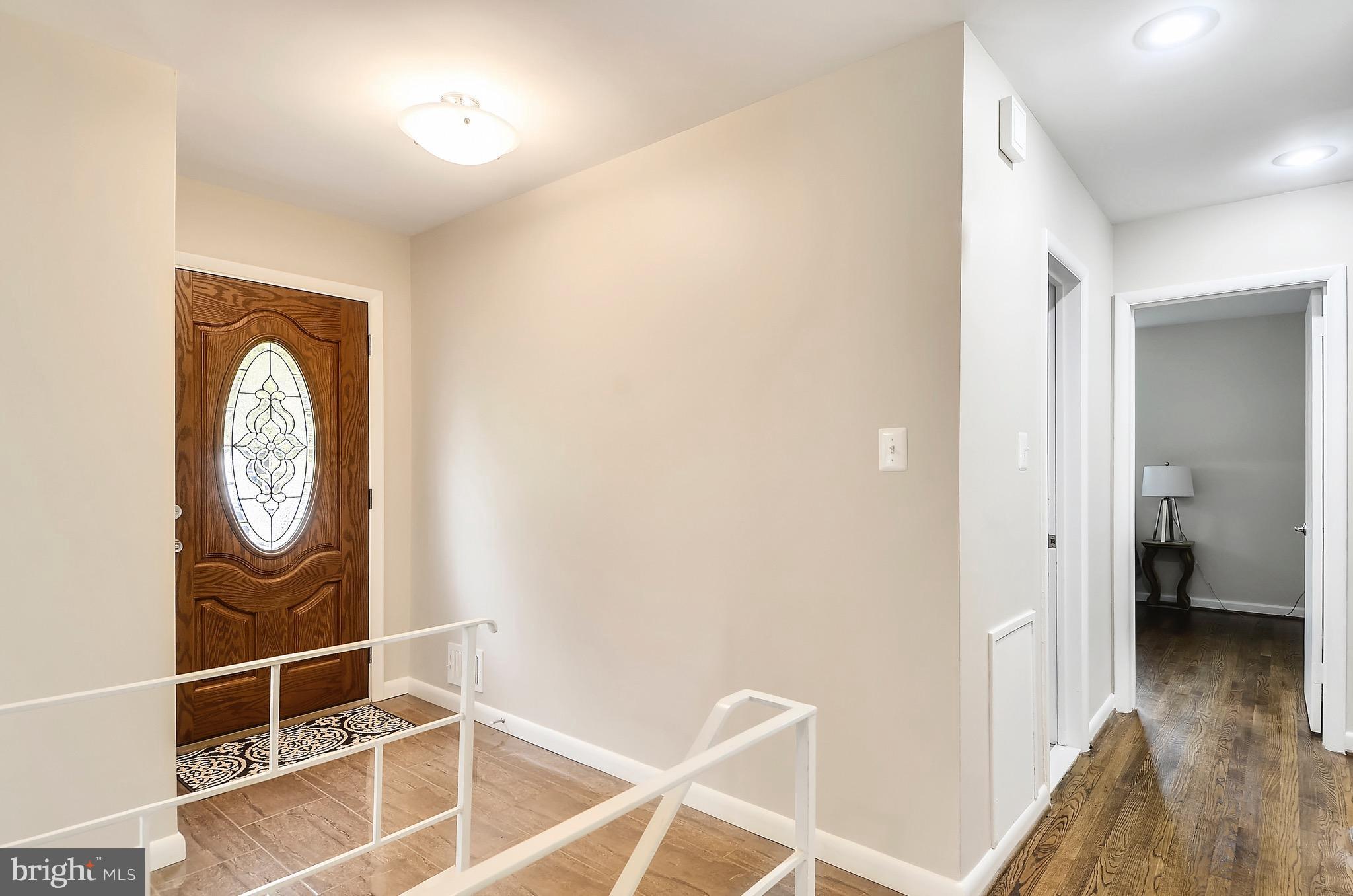 510 Waterford Road Silver Spring, MD 20901 - Photo 9 of 30 a view of a hallway with wooden floor and a bathroom view