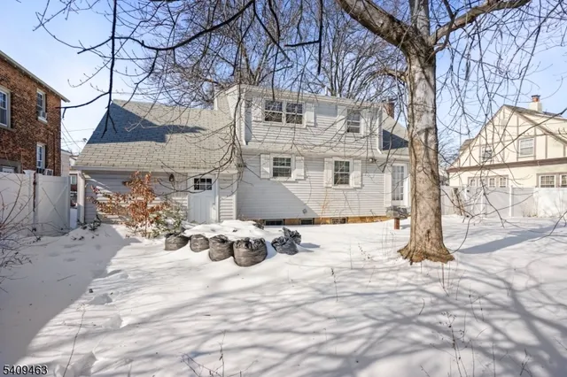 a view of a house with snow on the road