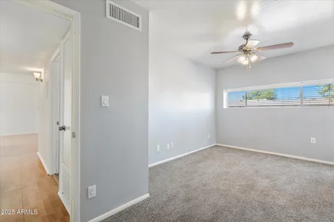a view of an empty room with a fan
