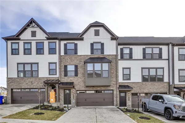 a front view of a house with parking space