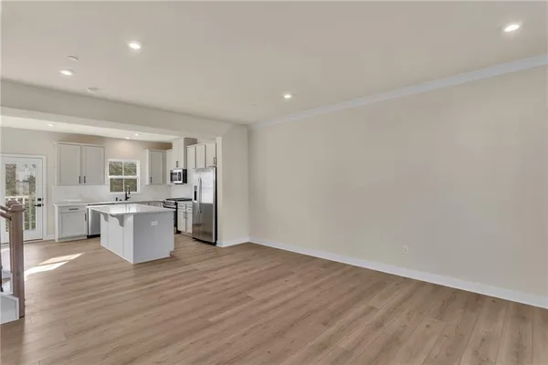 a view of a kitchen with a sink and wooden floor