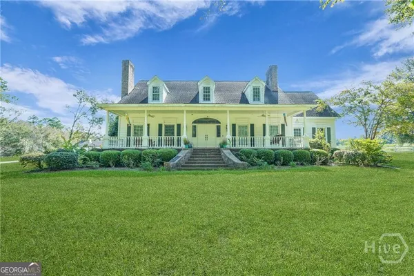 a front view of a house with garden