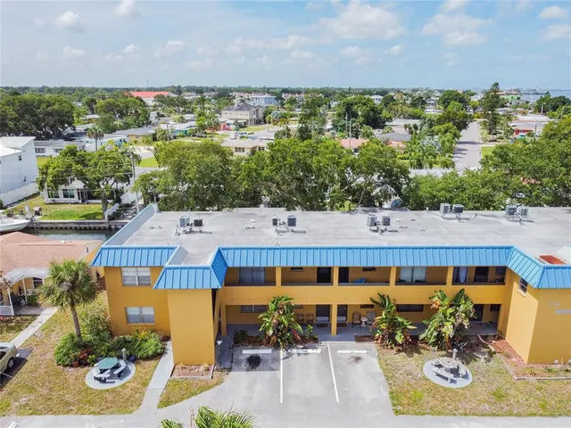 an aerial view of a house with garden space and outdoor seating