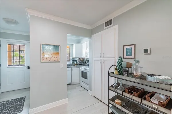 a kitchen with stainless steel appliances a stove and white cabinets