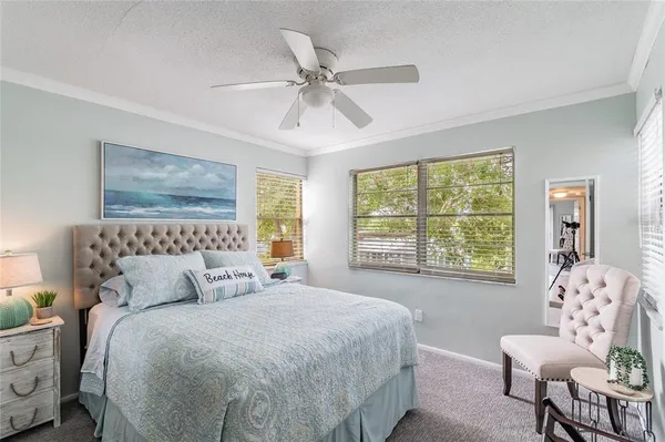 a bedroom with a large bed and a window