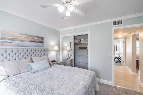 a spacious bedroom with a bed and a chandelier