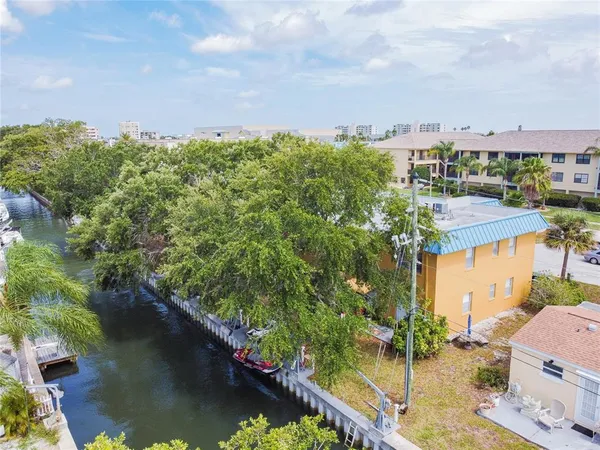 an aerial view of a house with a yard basket ball court and outdoor seating