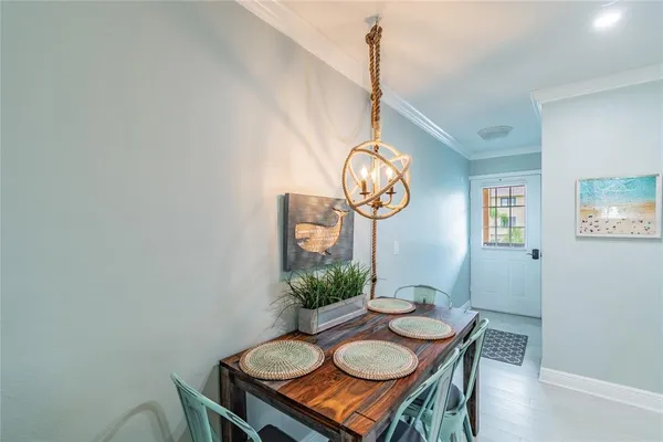 a view of a dining room that has a table and chairs in it