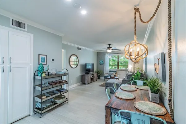 a living room with furniture a window and a chandelier