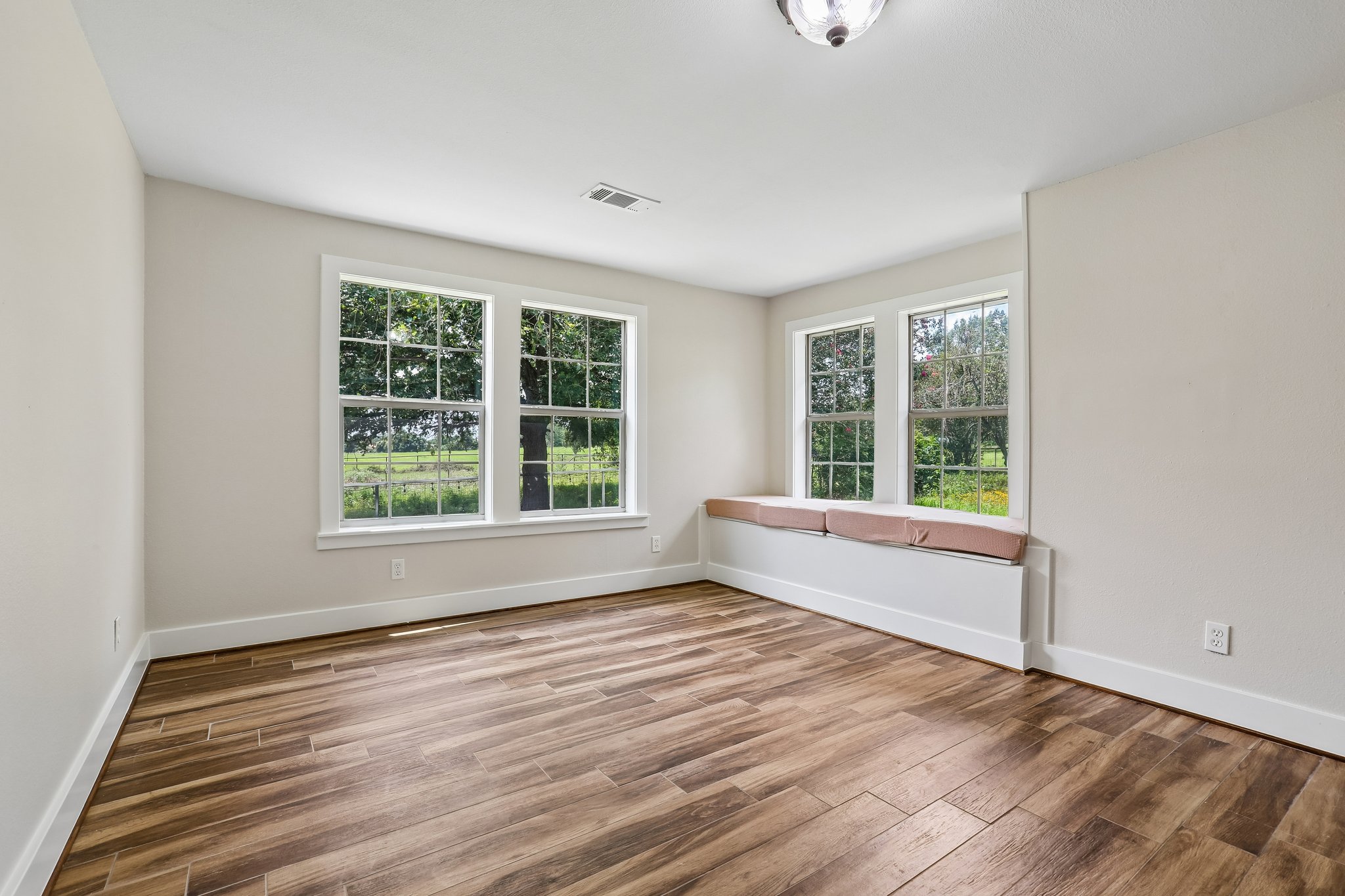 2089 Farm To Market Road 1704 Elgin, TX 78621 - Photo 12 of 31 Sun-filled room boasts abundant natural light, offering idyllic views through its multiple windows and a cozy window seat.