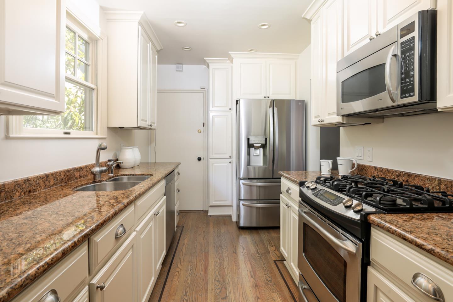 1104 Cambridge Road Burlingame, CA 94010 - Photo 18 of 34 a kitchen with stainless steel appliances granite countertop a stove refrigerator sink and microwave