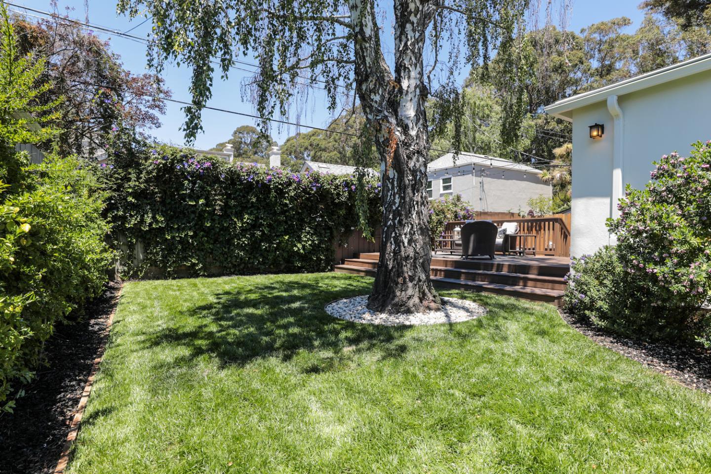 1104 Cambridge Road Burlingame, CA 94010 - Photo 29 of 34 a view of backyard with a table and chairs and a large tree