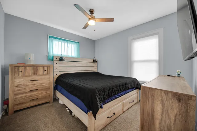 a bedroom with a bed and a dresser