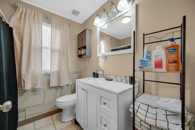 a bathroom with a sink toilet vanity and shower