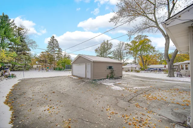 a view of a house with a yard and garage