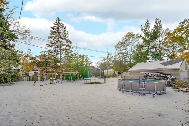 a view of patio with a table and chairs under an umbrella