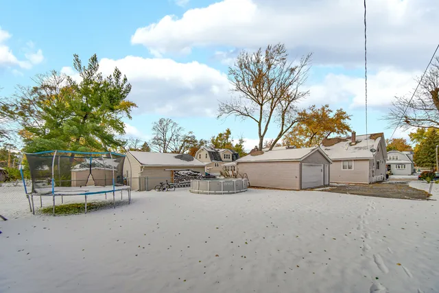 a view of white house with a table and chairs