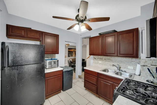 a kitchen with stainless steel appliances granite countertop a refrigerator and a sink